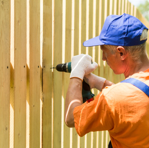 man installing new fence
